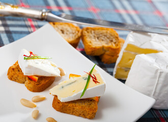Tasty canape with soft blue cheese and orange