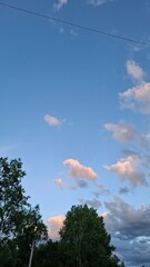 in the evening, sunset, beautiful clouds in the blue sky, summer season, nice summer weather