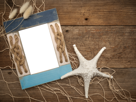 Beach coastal image with transparent picture photo frame painted blue and rope knots on a rustic old wood table, fishing fishnet netting, shells, ocean sea themed decorations. Customize DIY