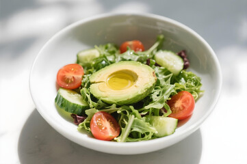 Fresh avocado salad with cherry tomatoes and cucumber — healthy vegan meal concept