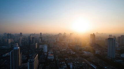 Fototapeta premium Urban skyline at sunset with a hazy atmosphere over the cityscape