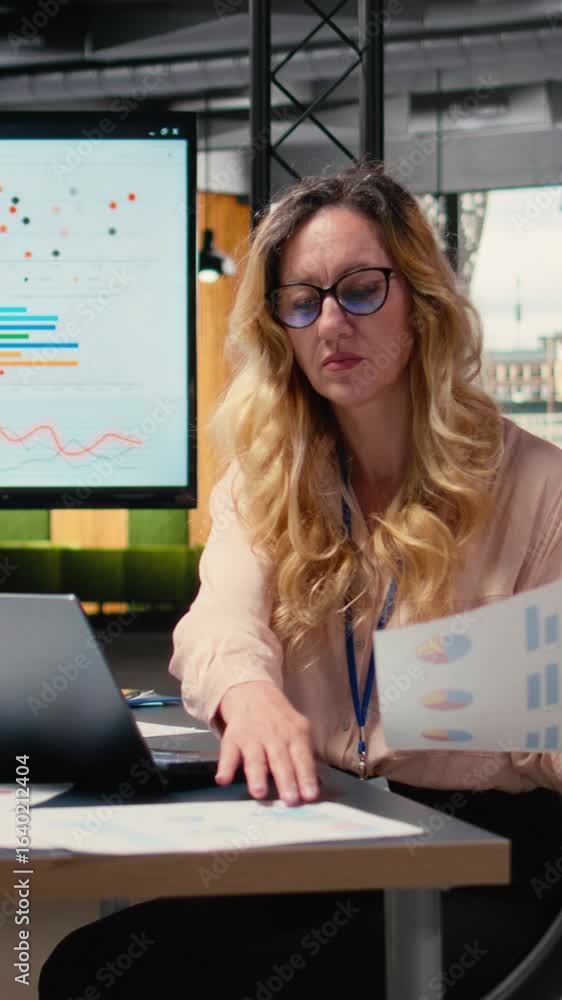 Poster vertical video ambitious entrepreneur writes a report informed by real time data insights, solving d