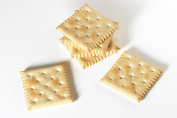 Saltine style Crackers pile on white background