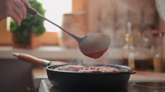 A chef uses a ladle to pour hot vegetable sauce over osso buco. veal shanks simmering in a pan The rich gravy coats the meat during the slow cooking process for a gourmet meal.