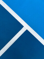 Pickleball Court Closeup View. Vibrant colored racquet sport court closeup, angled view. Serving and out of bounds lines create a geometric pattern.