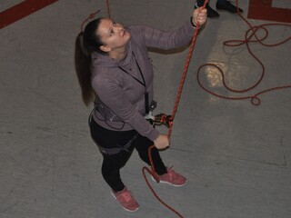 woman belaying in climbing gym