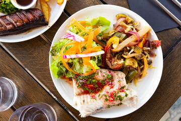 Blue ling fillet with stewed vegetables. French dish