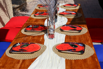 Naklejka premium San Diego, CA USA on September 17, 2022. A table setting for a children's Spiderman theme birthday celebration party.