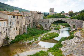 Medieval vaulted arch bridge over Orbieu river in Lagrasse, France..