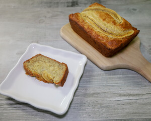 A slice of a warm very moist piece of banana bread with lots of banana and vanilla pudding mix in...