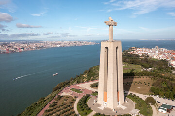 Aerial drone view of monument Sanctuary of Christ the King. Majestic statue overlooks cityscape of...