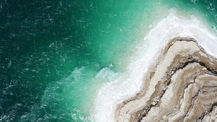 Aerial view of the Jordanian side of the Dead Sea, on a day of strong wind, with a strong concentration of salt on the shores.