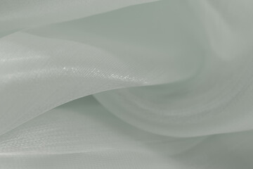 Light grey or white translucent fabric with soft folds and flowing texture, creating a minimal and...