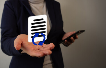 Person's hand holding a 3D virtual icon of a document with round refresh arrows