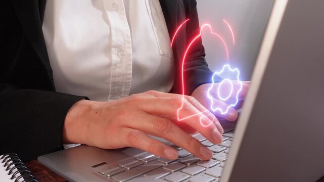User Alert Optimization concept. Close-up of a businesswoman's hands working on her computer with a virtual icon of a bell and gear.