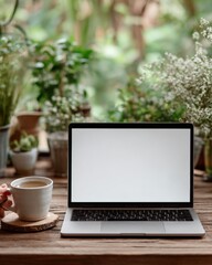 Fototapeta premium Laptop Mockup on Wooden Desk Surrounded by Plants and Coffee Cup for Remote Work Concept