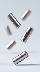 Naklejka premium Dynamic composition of levitating batteries on light background for energy concept