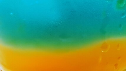 Vibrant abstract close-up of a colorful liquid background with a smooth gradient transition from...