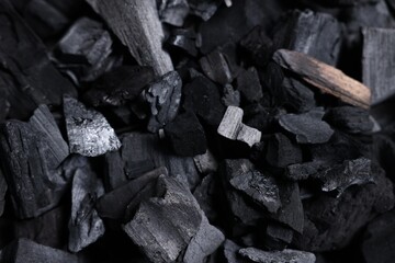 Pieces of black coals as background, top view