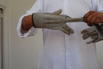 Working objects, screws, and tools with a man wearing gloves