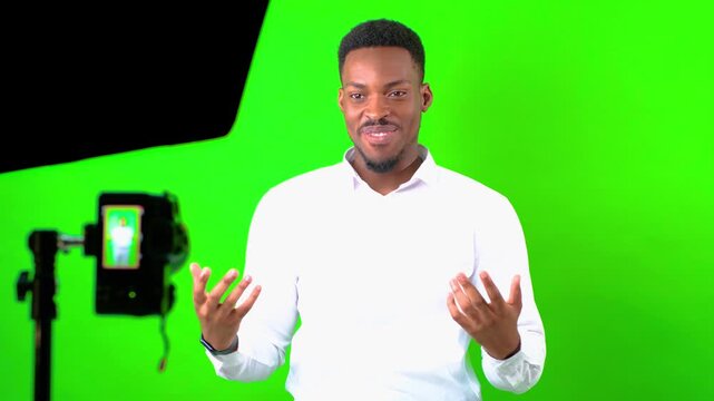 Professional business man, an african american content creator, shares valuable insights on public speaking and presentation techniques in a studio equipped with a green screen