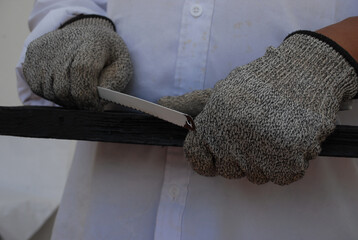 Working objects, screws, and tools with a man wearing gloves