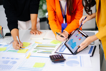 Business People Talking Discussing with financial document data charts and graphs Team business meeting with smart phone and laptop and digital tablet computer