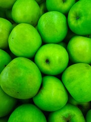 close up fresh green apples in a frame on market