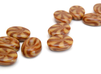 Caramel candies isolated on white background