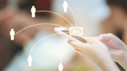 Woman using smartphone sending message from E-mail to other people with network.