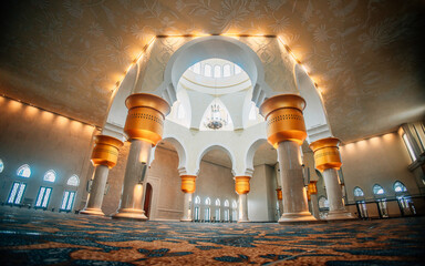Interior view of grand mosque Sheikh Zayed Indonesia with ornate pillars, arches, and patterned...
