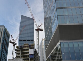 Construction of skyscrapers with high-rise cranes. The clear, blue sky of Warsaw and the...