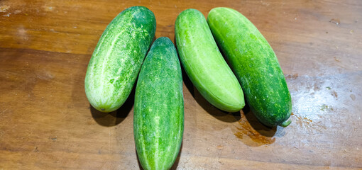 fresh cucumbers on wooden table