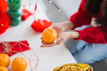 Happy Chinese New Year Happy asian woman hand holding Orange