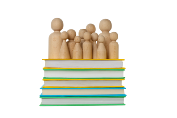 Wooden figures atop vibrant books for school, isolated on white, PNG