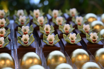 gourmet chocolate sweets with orchids, elegant floral dessert for events, luxurious handcrafted...