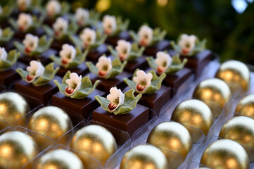 gourmet chocolate sweets with orchids, elegant floral dessert for events, luxurious handcrafted...