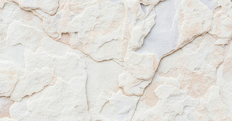 Close-up of an irregular white stone wall showing textured surfaces and natural imperfections in a balanced, clean aesthetic.