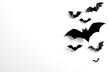Fototapeta premium A collection of bat silhouette decorations arranged on a surface. It's a symbol of mystery and the spooky holiday
