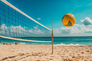 Yellow volleyball ball flying in the air on the court on the sand beach with the volleyball net. Sea or ocean waves behind,