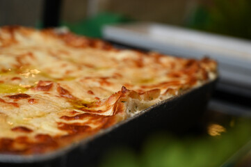 a lasagna in a baking dish, a healthy and gourmet catering dish, a delicious chicken lasagna

