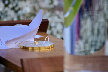 wedding table setting, wedding rings on a decorative plate, ceremony vows and golden rings, a...