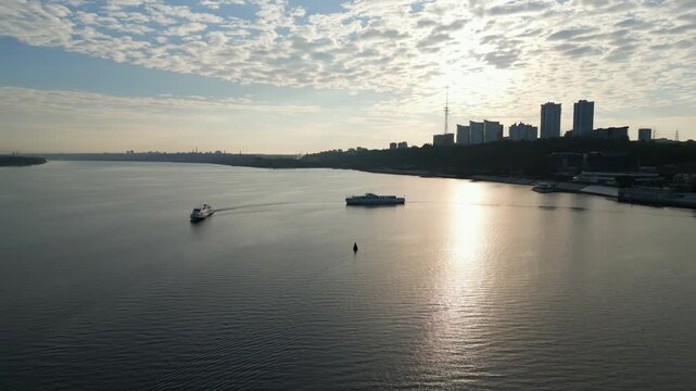 Passenger ferry approaching another ferry on dnipro river at sunrise. Clip