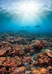 Fototapeta premium Underwater Coral Reef Scene with Sharks and Bright Sunlight in Clear Ocean Water