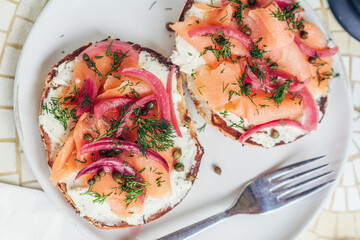 Lox Bagel with Pickled Onions and Capers — Overhead with Fork