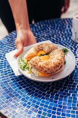 Freshly Prepared Bagel Sandwich Served on White Plate