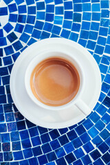 Freshly Brewed Espresso in White Cup on Blue Mosaic Table