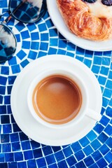 Espresso and Pastry on Blue Mosaic Café Table
