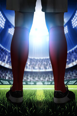 Soccer Player Standing on Stadium Field with Bright Lights