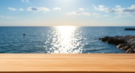 Obraz premium Sunset Over Calm Ocean with Rocky Shoreline and Wooden Deck in Foreground